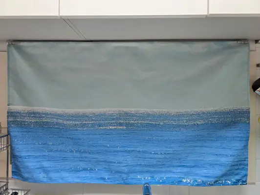 Vertical Fabric Poster (M) Purchased 28X43'' 제작 후기 Why did I find out about this place now ㅠㅠ 
It's so good! ! 

I wanted to make a fabric poster instead of a kitchen curtain, so I looked it up, 
but the production was so expensive.. 
I was about to give up when I found this place, and they said they'd make it in a week if I just put in the picture I wanted! ! The size was perfect too ❤️❤️ 

I just put a horizontal picture on a vertical poster, 
but they kindly called me and asked if I had made the picture horizontally, and they said they'd drill a hole for me ㅠㅠ (I'm touched) 

The hole was covered so well that it didn't interfere with the picture at all ㅎㅎ 
I'm going to order again later if I get the chance ~~ 

I can't go to the beach often in the summer, so I replaced it with a poster, and it's so cool! Thank you 😁 - 마플 리얼 후기 